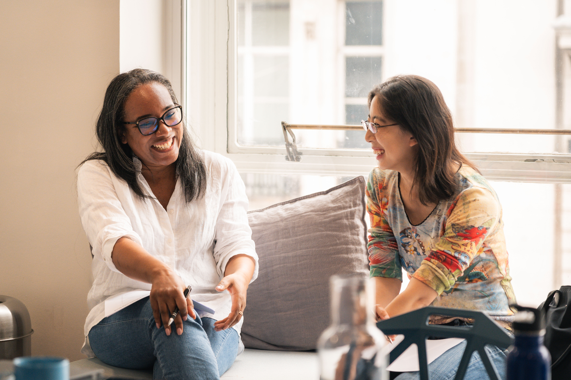 Two women in conversation, laughing together